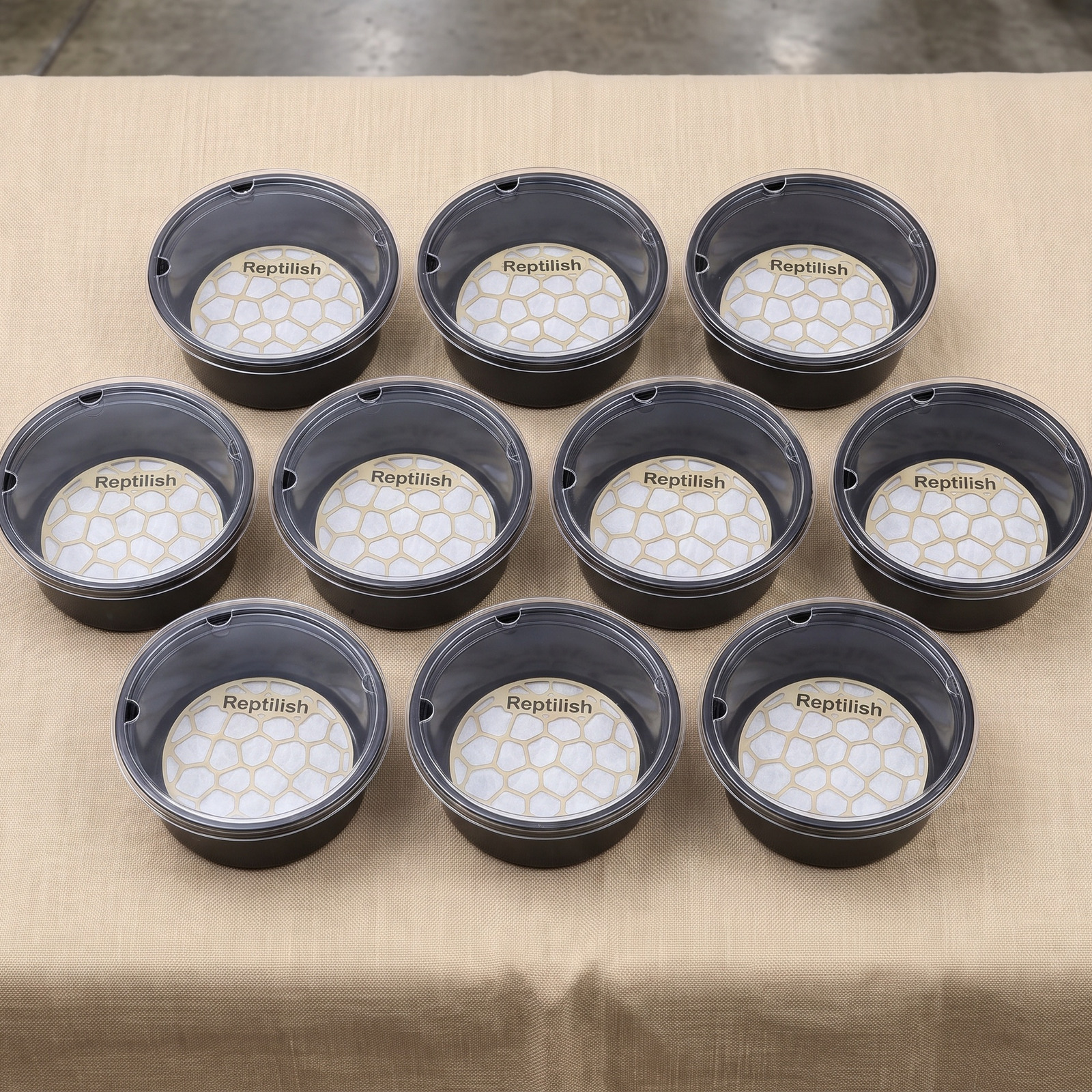 Deli cups with acrylic lids lined up on an expo display table