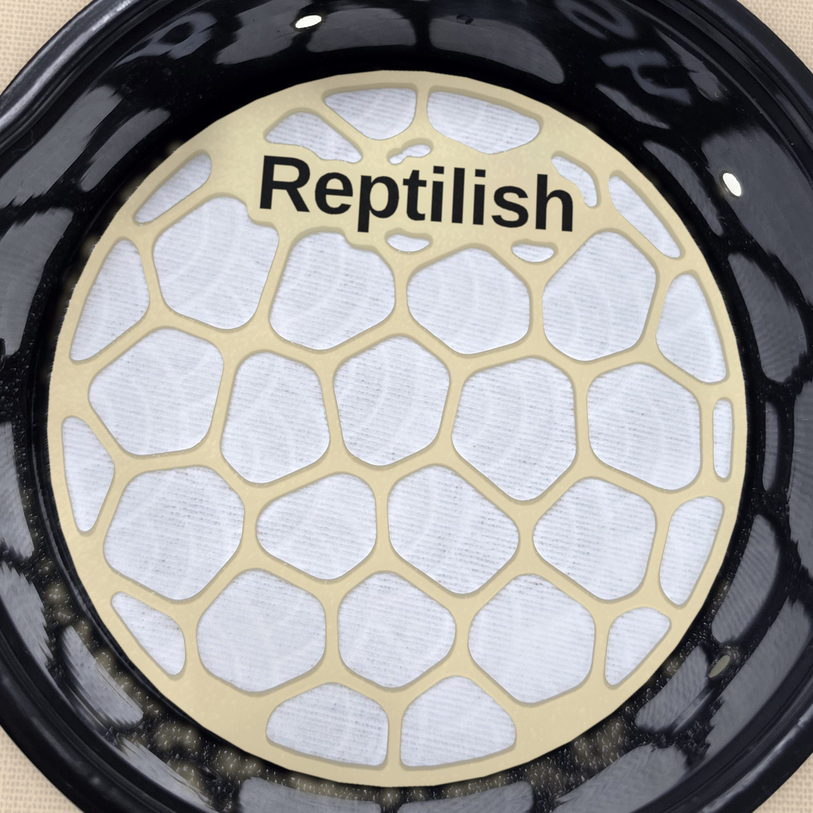 A round Desert Tan engraved Pebble Plate inside a deli cup