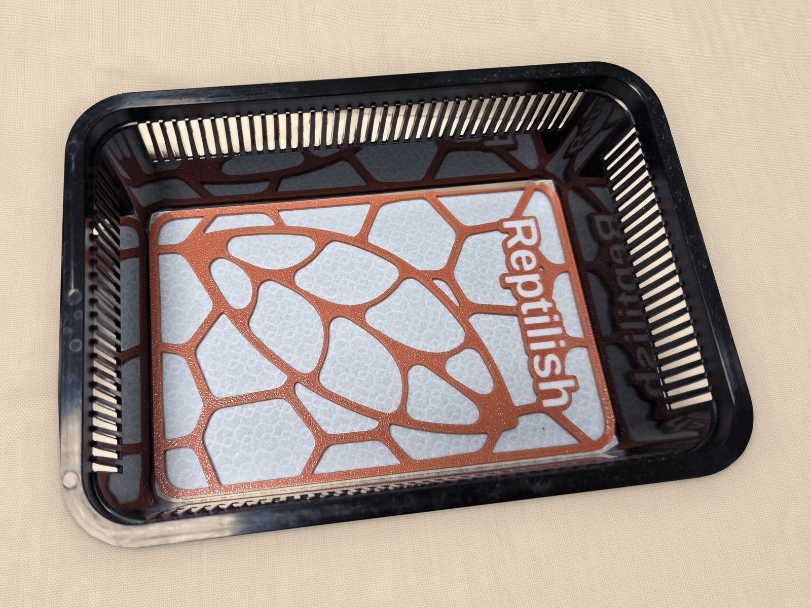 A rectangular Terracotta engraved Pebble Plate on the pad inside a small tub